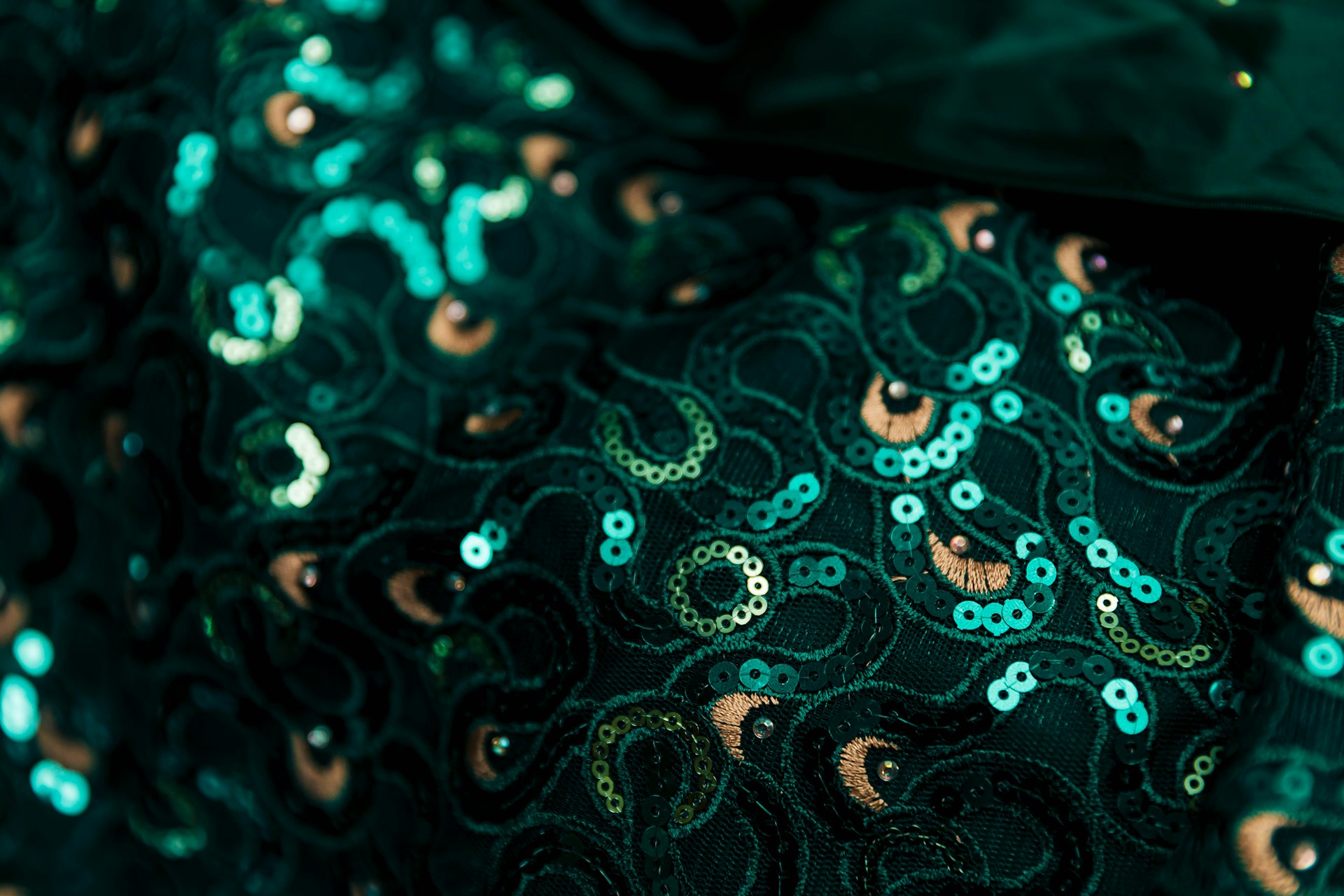 a close up of a green and gold tie